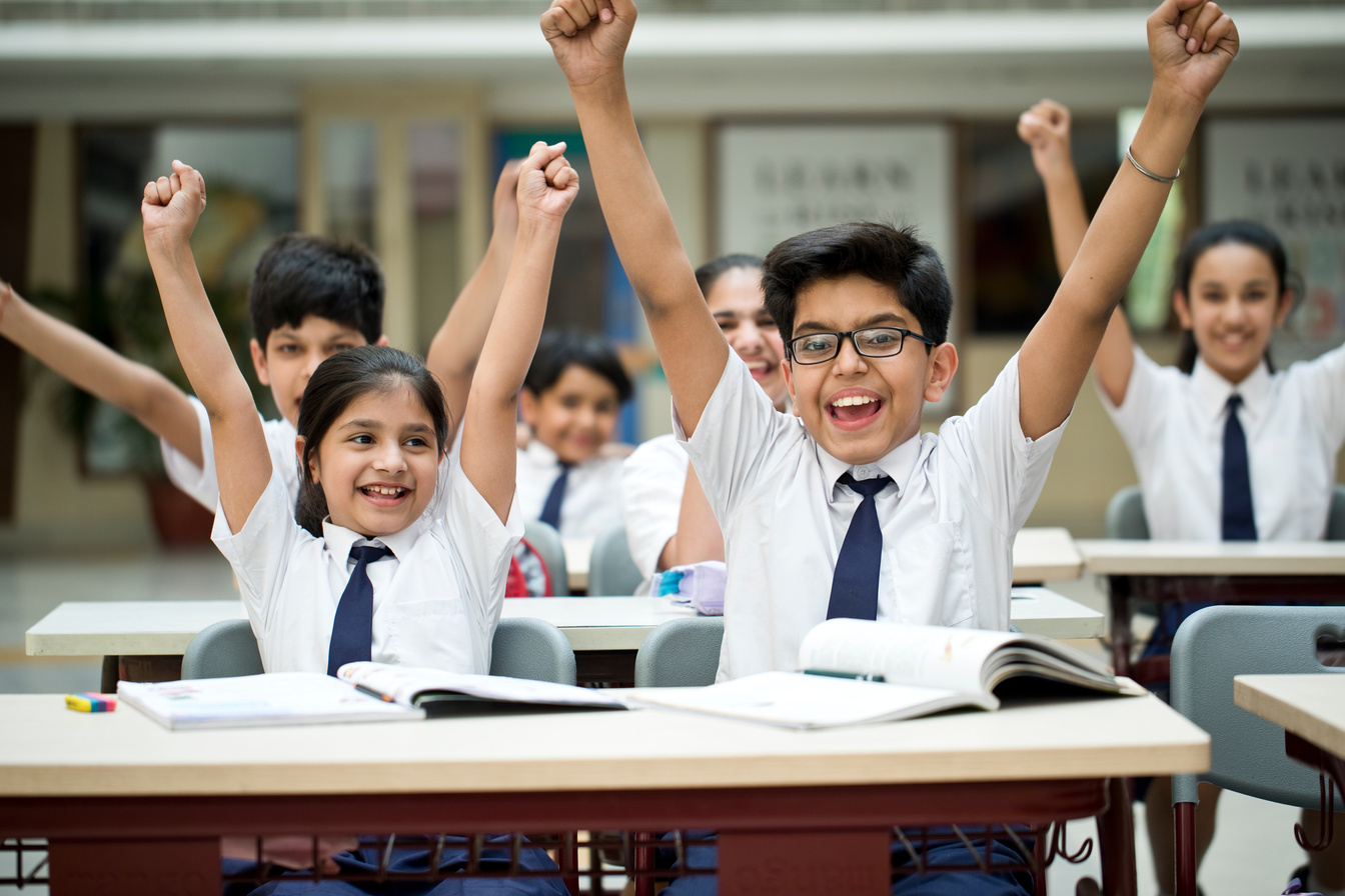 Children cheering in classroom