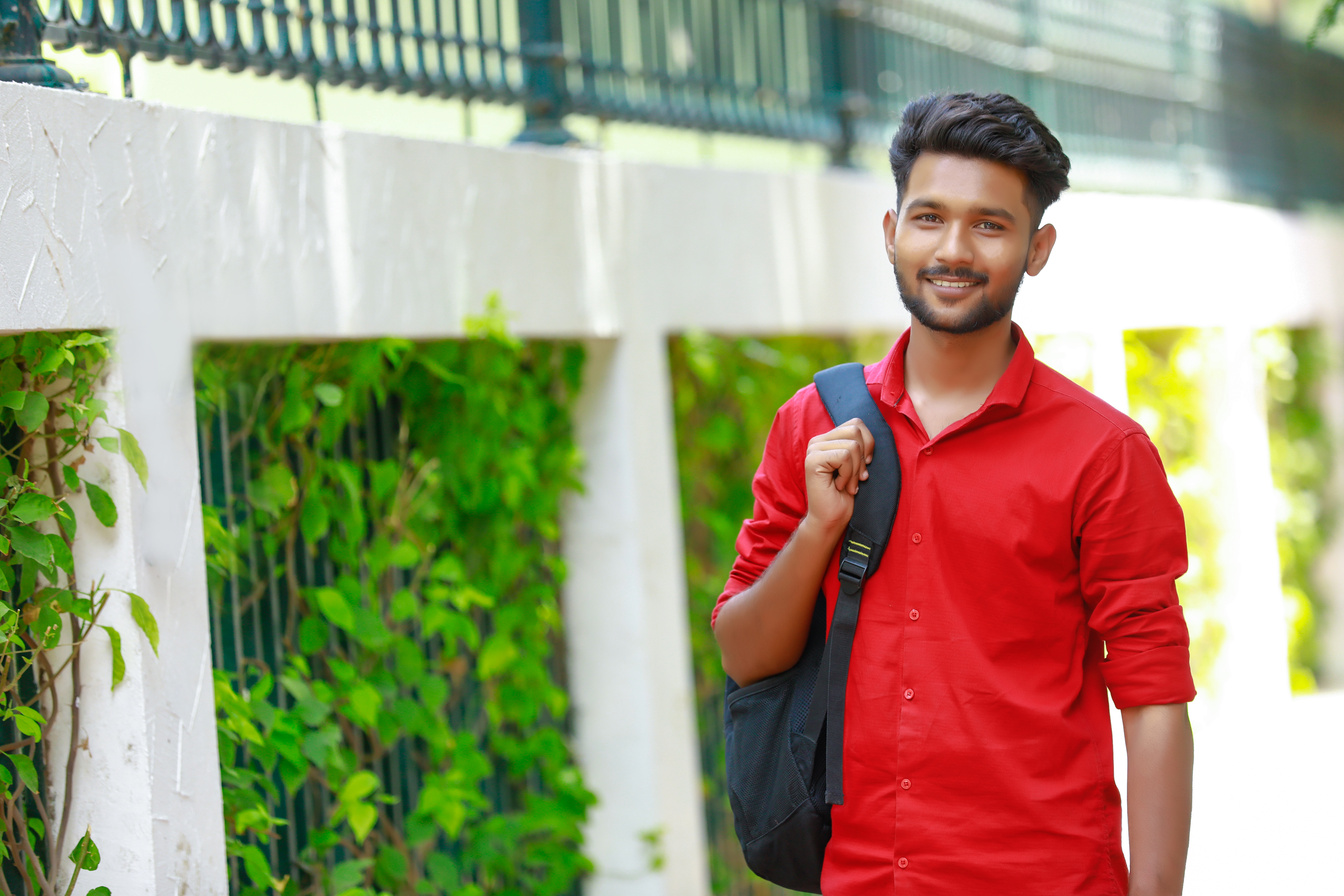 Indian college boy with Holding bag